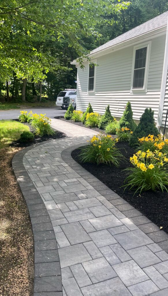 Custom walkway installation with stone pavers and landscaping by Marcelino Hardscaping. Serving Central Massachusetts, the Metrowest region, and parts of Greater Boston.