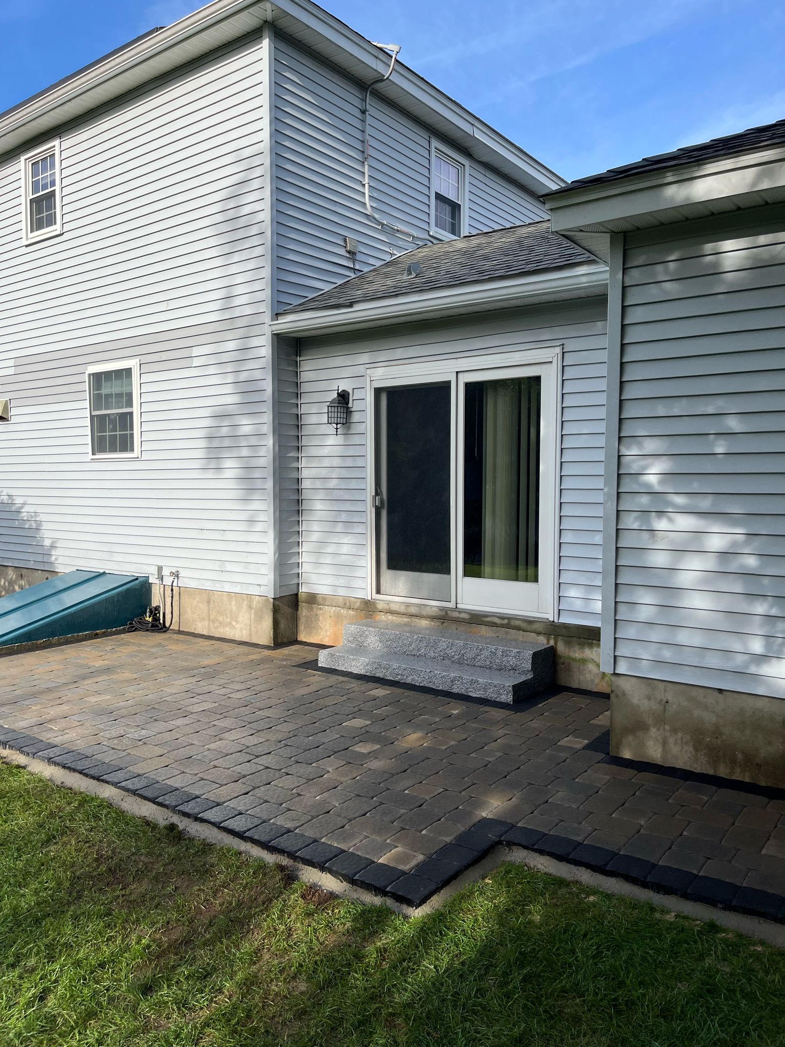 Completed backyard patio with stone pavers, built by Marcelino Hardscaping. Serving Central Massachusetts, the Metrowest region, and parts of Greater Boston.
